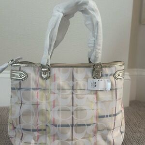 Spring into Spring with this Coach White Signature Multicolor Stripe Tote